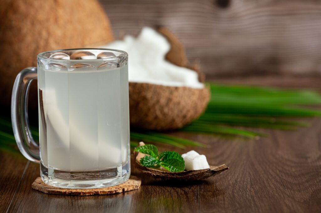 glass-coconut-water-put-dark-wooden-background