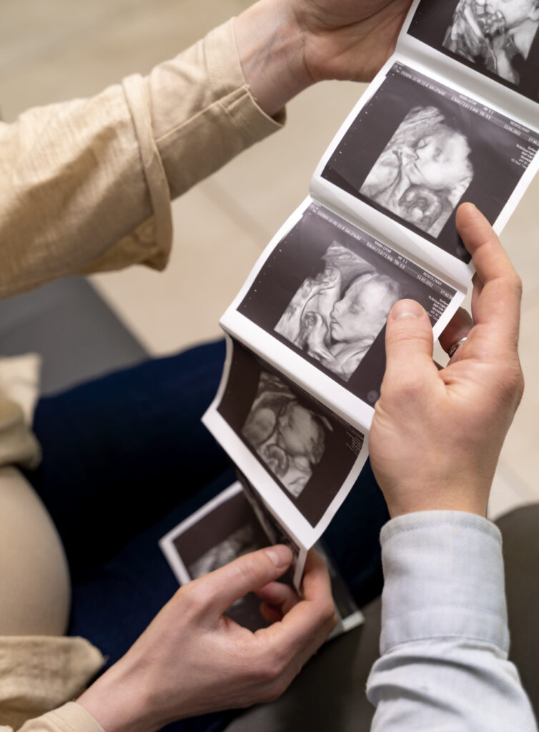 gynecologist-offering-couple-ultrasound-pictures
