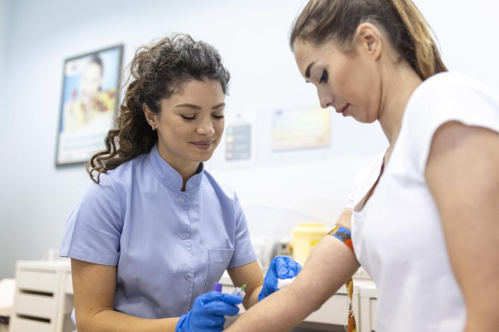 medical-technologist-doing-blood-draw-services-patient-lab-assistant-with-sterile-rubber-gloves-taking-blood-sample-from-patient