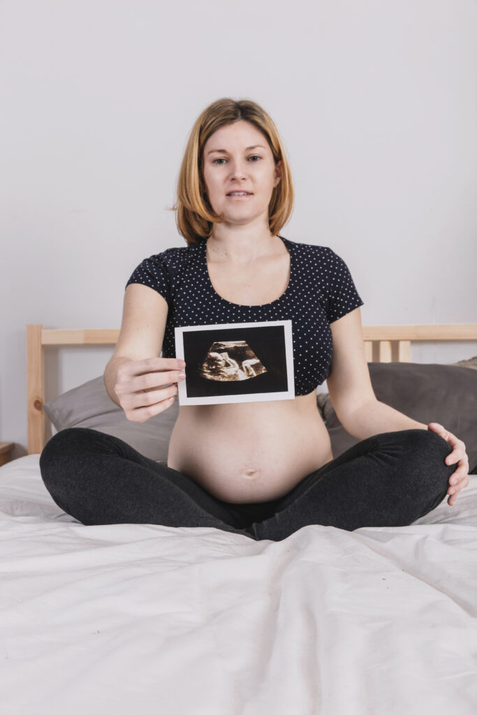 pregnant-woman-bed-showing-ultrasound