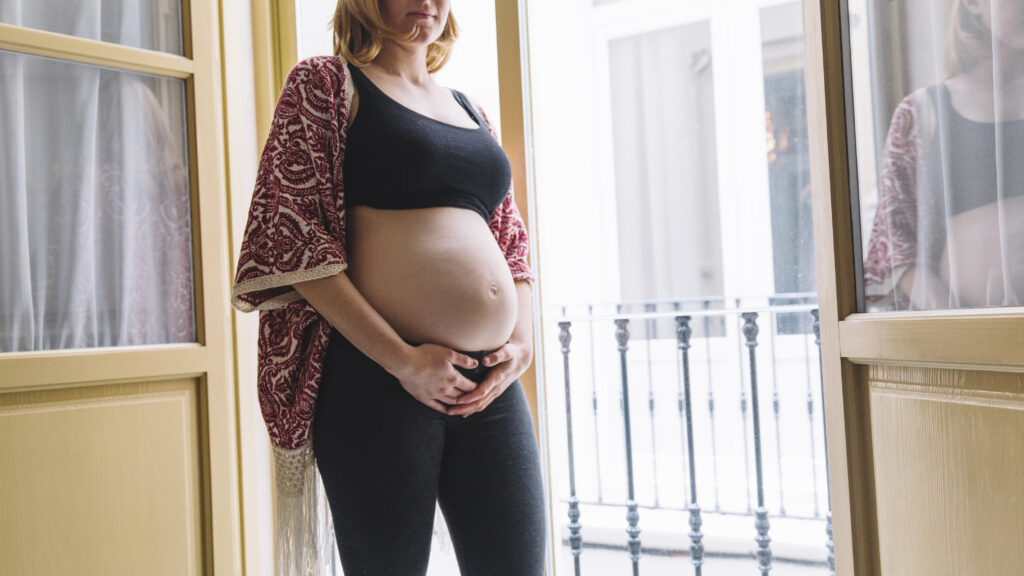 pregnant-woman-front-balcony