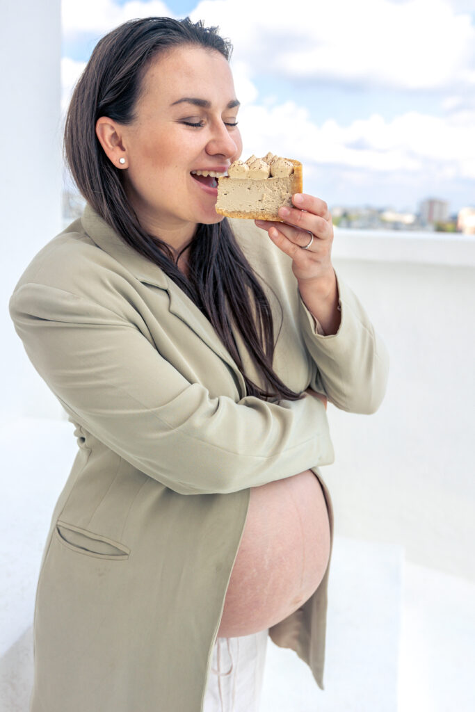 Pregnant woman with a cake in her hands. Concept of style and pregnancy.