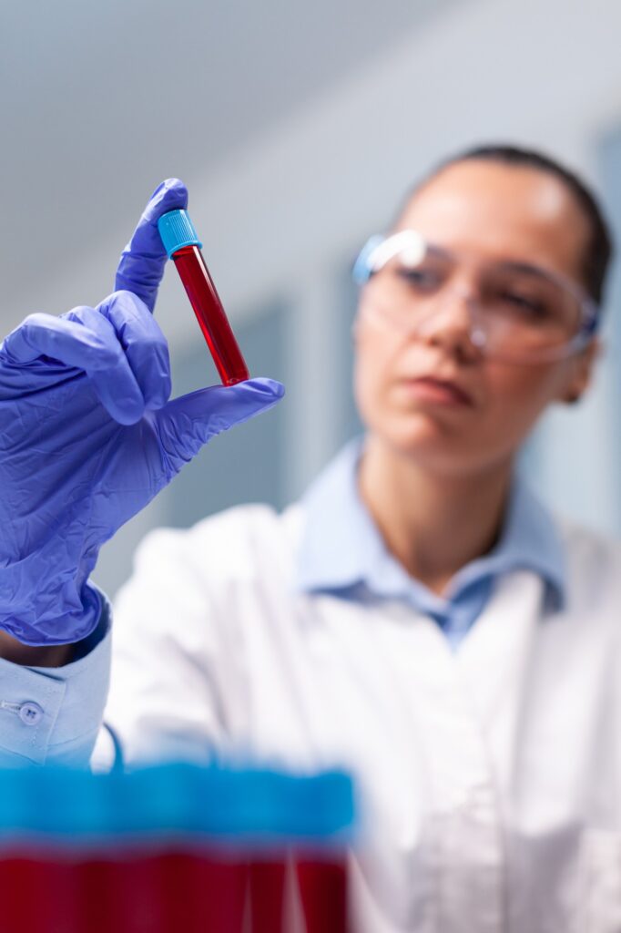 specialist-woman-doctor-looking-clinical-vacutainer-dna-blood-analyzing-biology-expertise