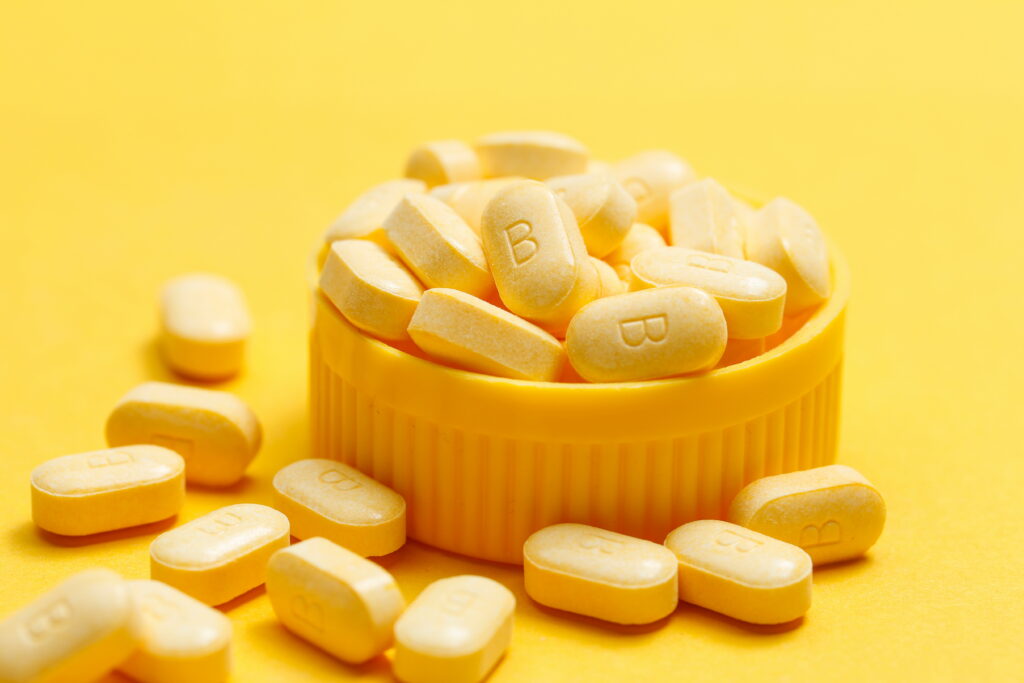 vitamin B tablets on yellow background